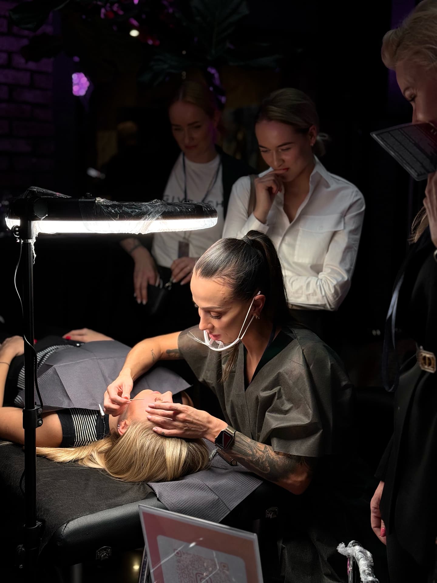 Marija Meshka performing a live permanent makeup demo on stage