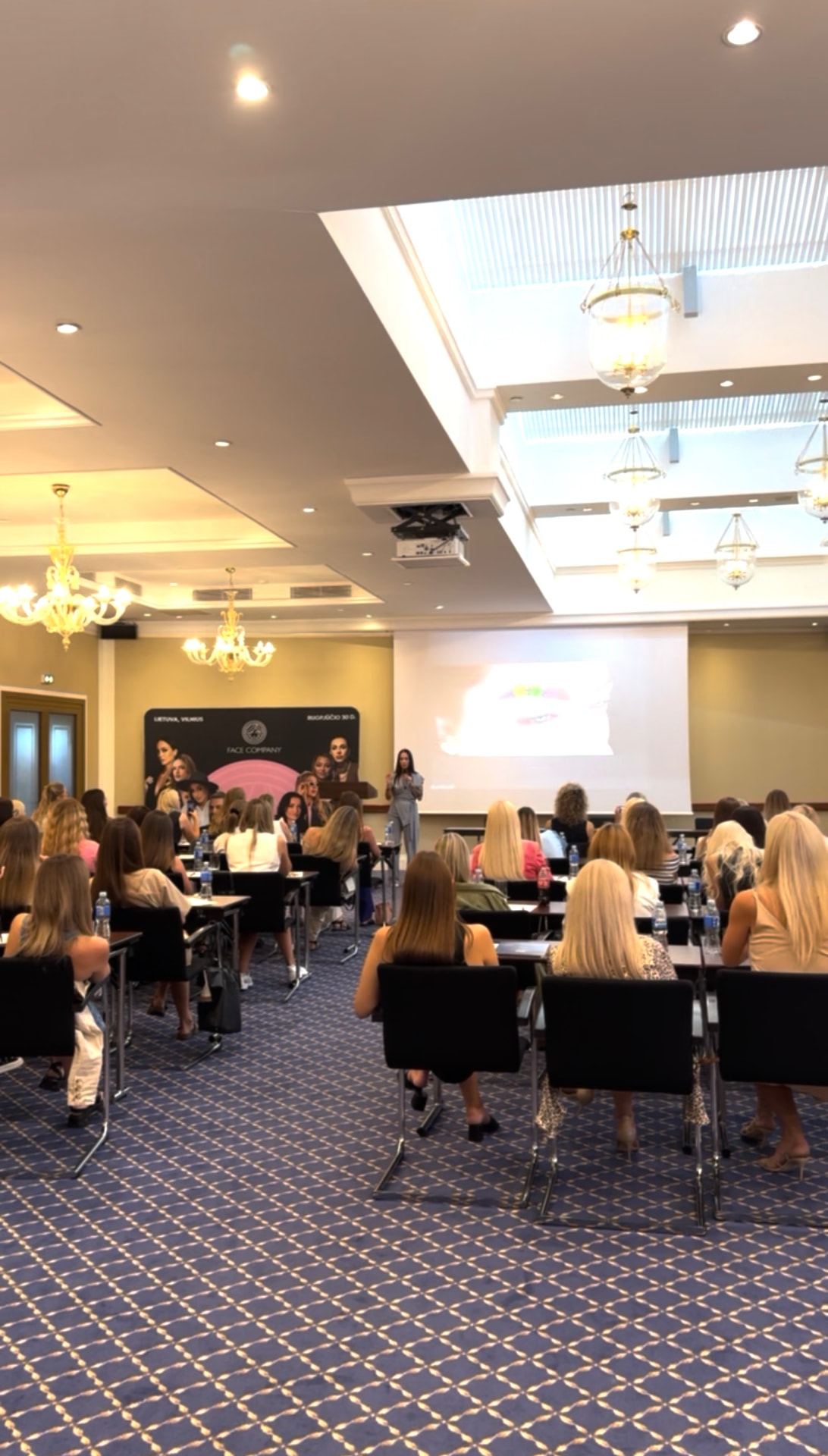 Marija Meshka presenting to a full seminar room in Vilnius